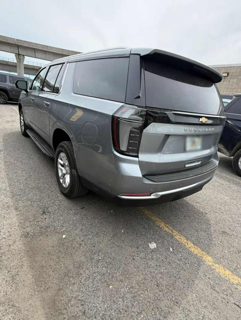 Wide shot of the full Chevrolet Suburban from the rear after repair.